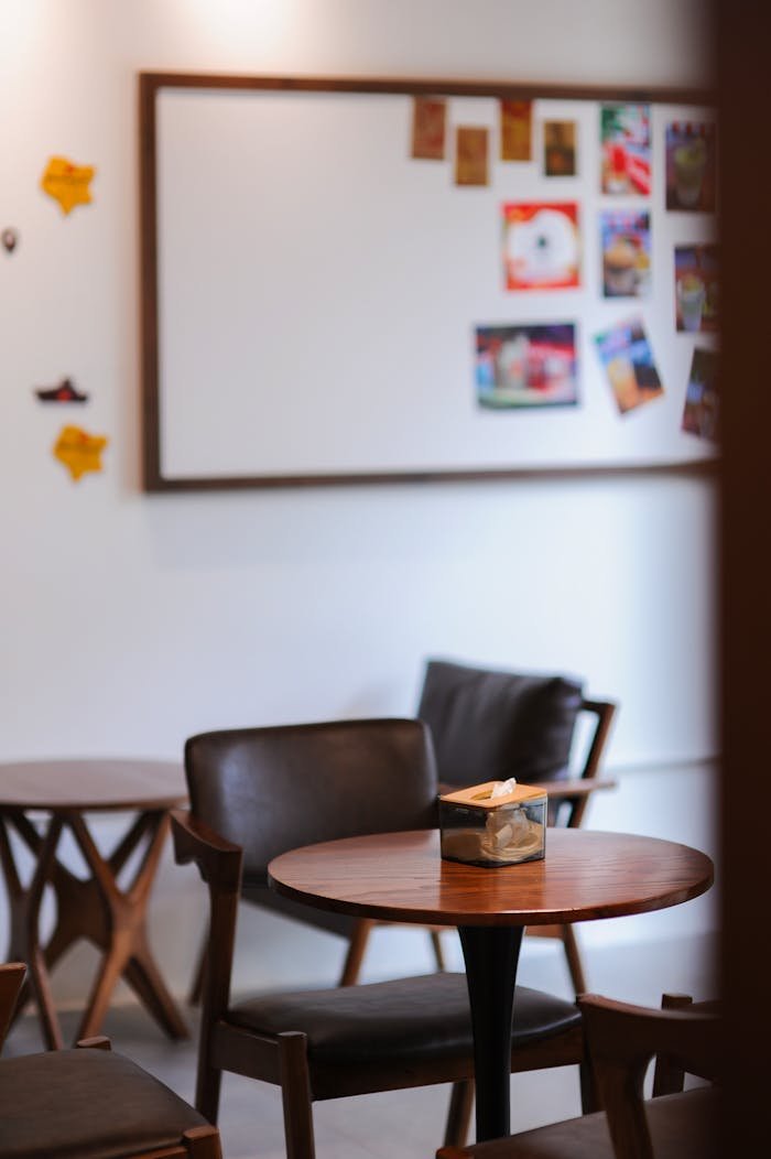 Warm and inviting café setting in Hà Nội with mid-century modern furniture and a creative bulletin board.